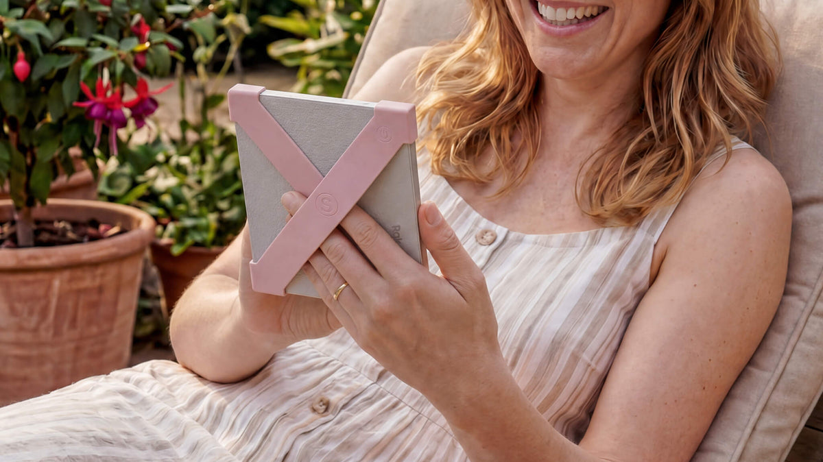 Reading one-handed with blush Strapsicle straps on a Kobo e-reader