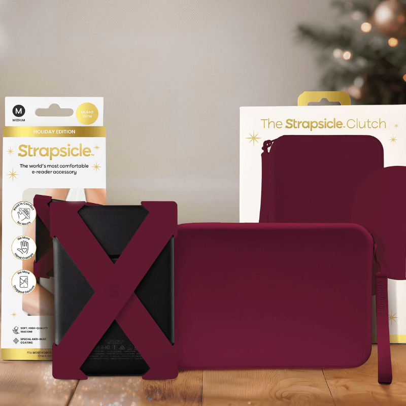 A mulled wine straps and clutch with packaging on a wooden surface with blurred lights in the background