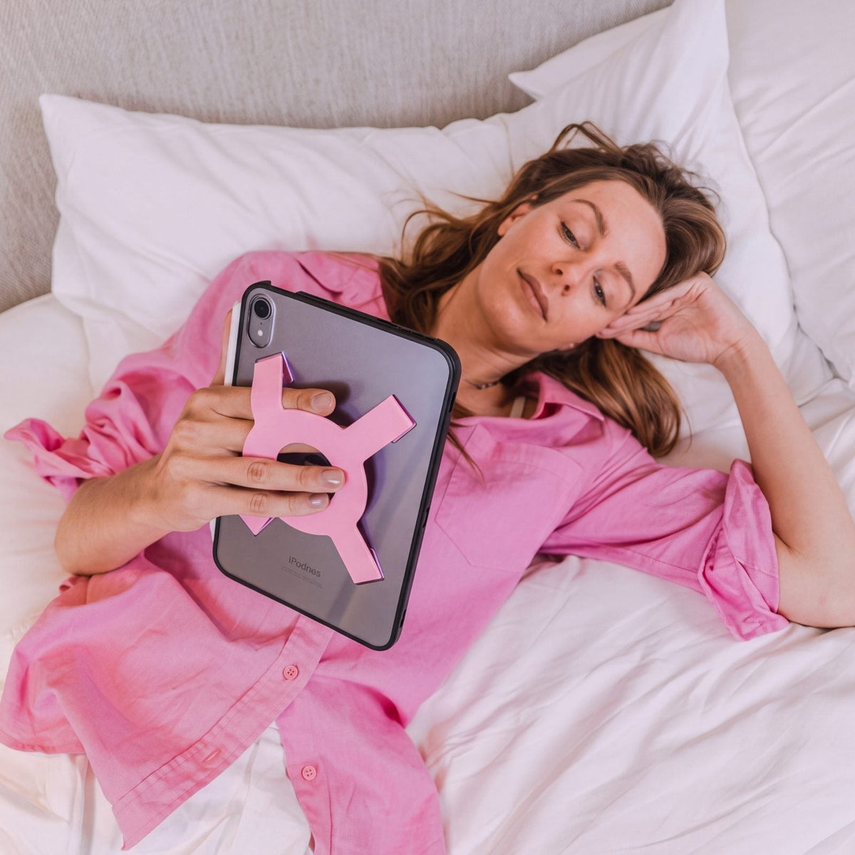 Woman laying back reading on an iPad mini all-groups