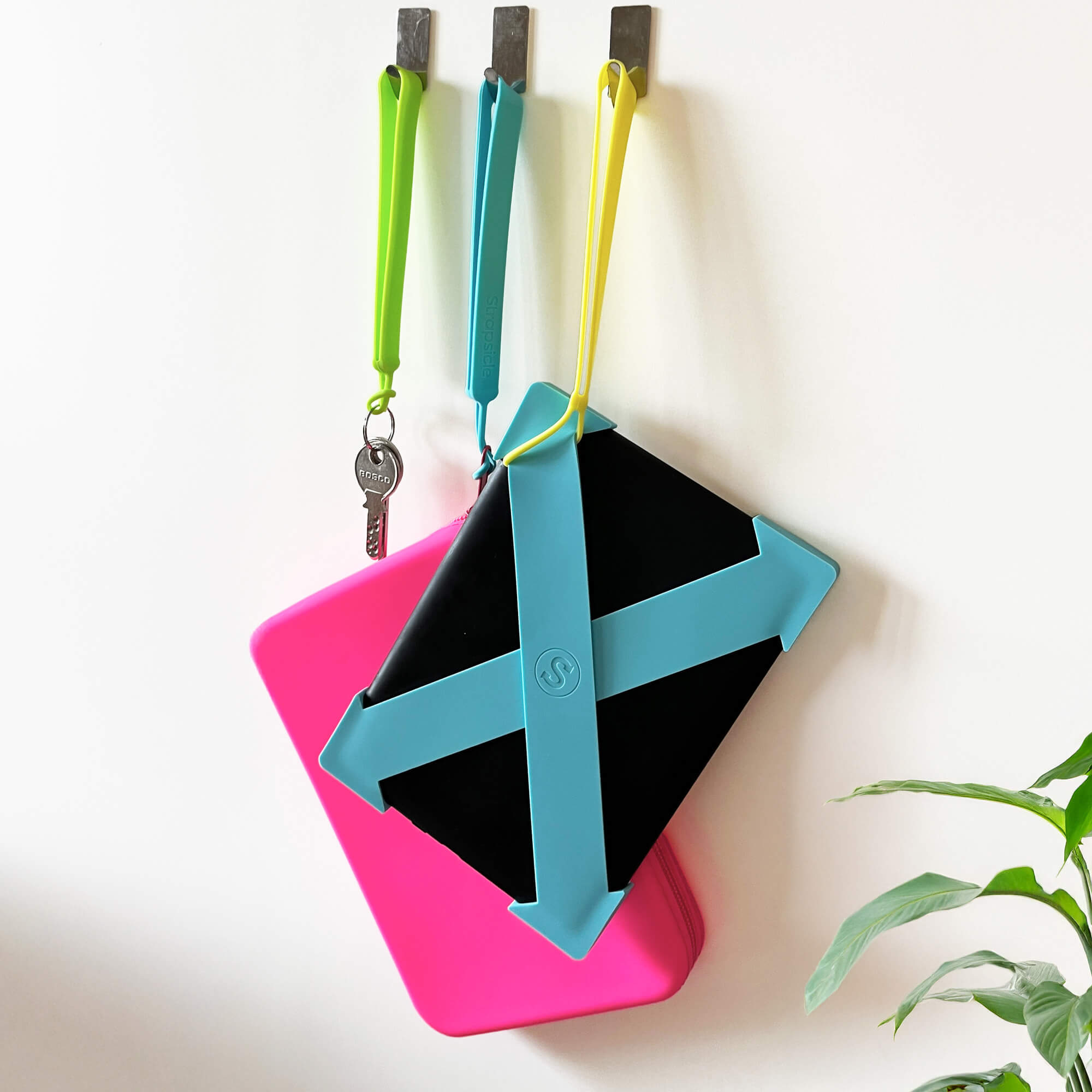 Colorful geometric keychain holder with pink, blue, and yellow components on a white background.