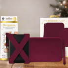 A mulled wine straps and clutch with packaging on a wooden surface with blurred lights in the background