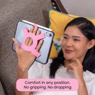 Woman holding an iPad mini comfortably with the Strapsicle case all-groups